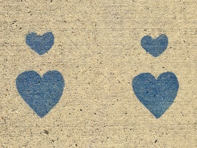 blue hearts stenciled on concrete sidewalk