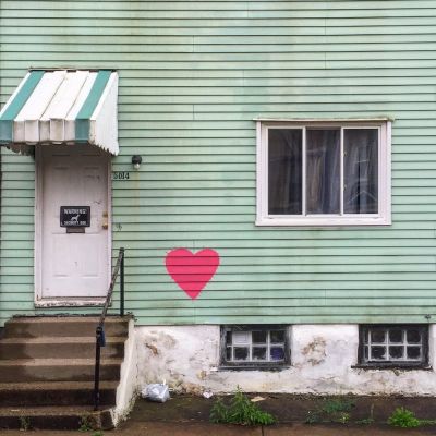 wood frame house with red heart painted on green siding, Pittsburgh, PA