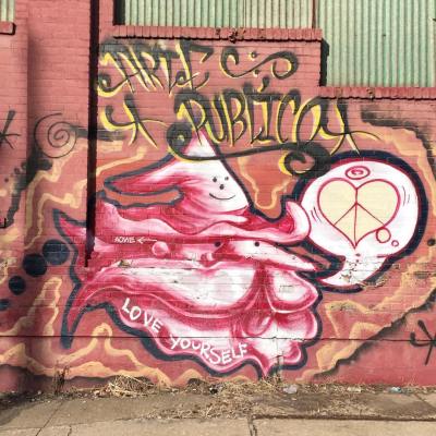 mural on brick wall including combined heart and peace sign, Pittsburgh, PA