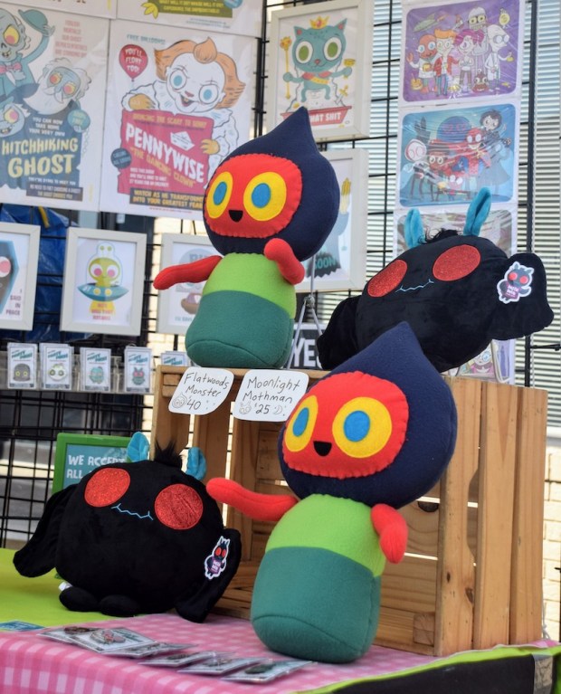 stuffed toys of Flatwoods Monster and Moonlight Mothman for sale at the 2019 Mothman Festival, Point Pleasant, WV