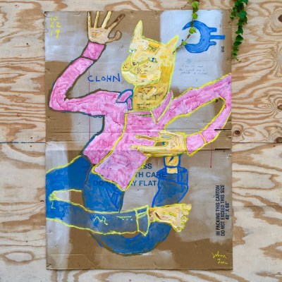 street art painting of cat in pajamas on cardboard