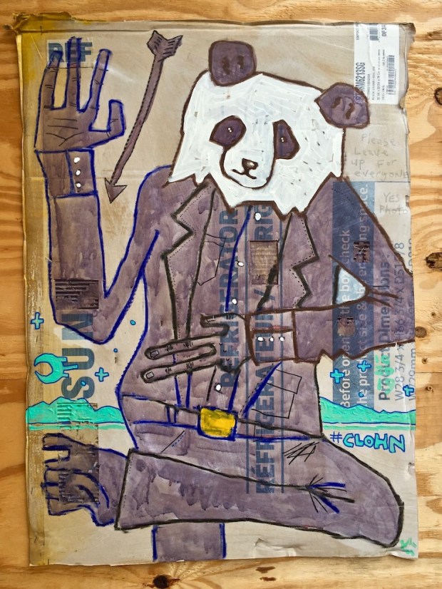 street art painting of polar bear in a brown dress suit on cardboard