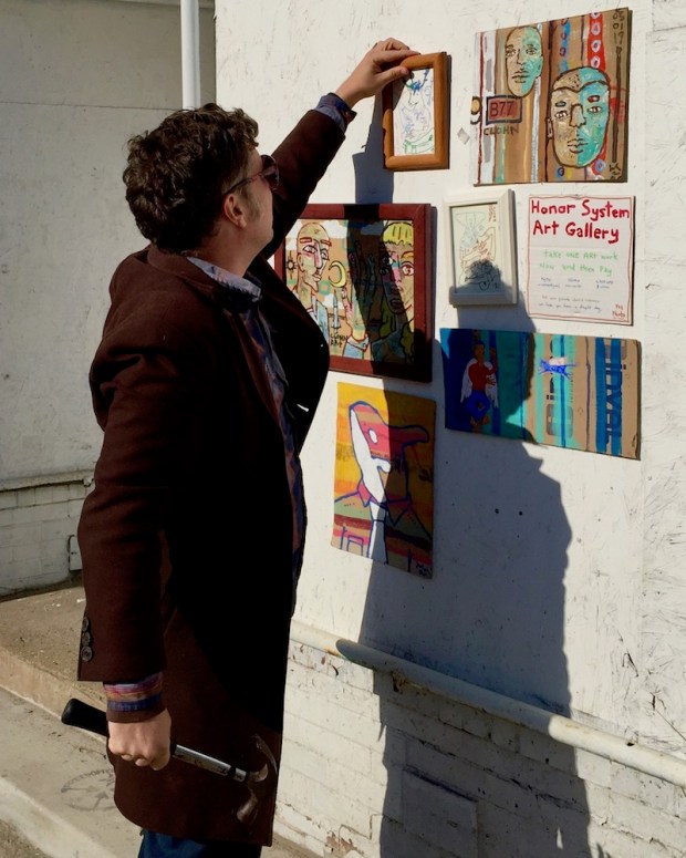 artist John Lee (aka "Clohn Art") installing Honor System Art Gallery, Pittsburgh