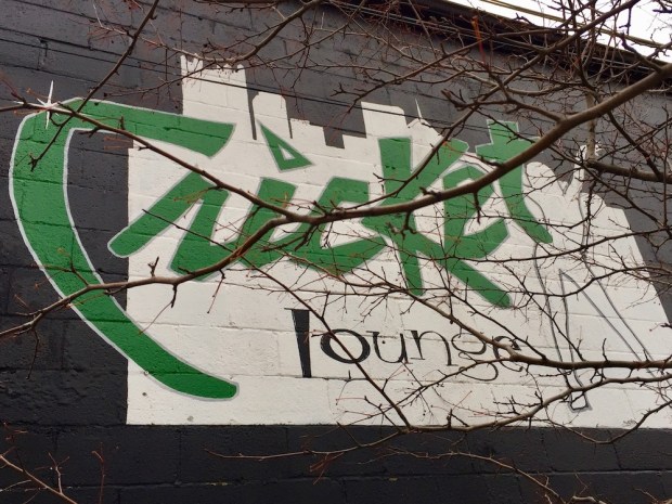 painted sign for Cricket Lounge including skyline of downtown Pittsburgh