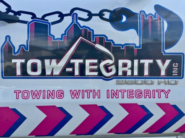 logo for Tow-Tegrity towing service including the Pittsburgh skyline and giant hook