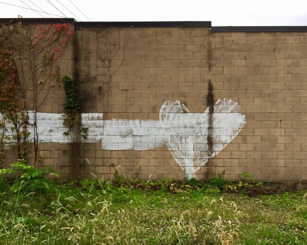 graffiti painted heart on cinderblock wall