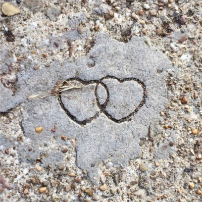 imprint of two hearts in sidewalk cement