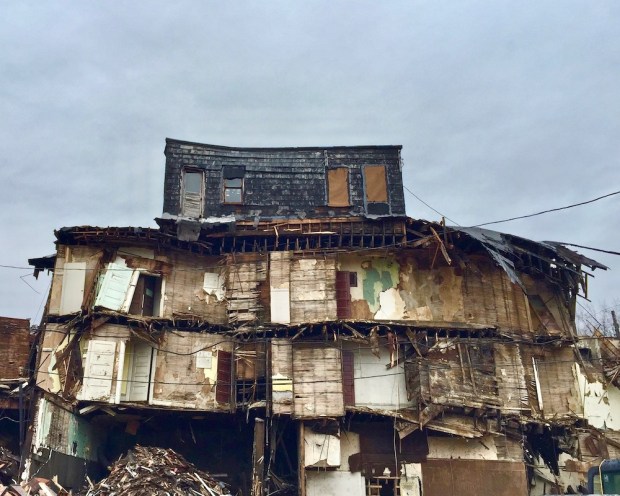 four-story building mid-way through being torn down