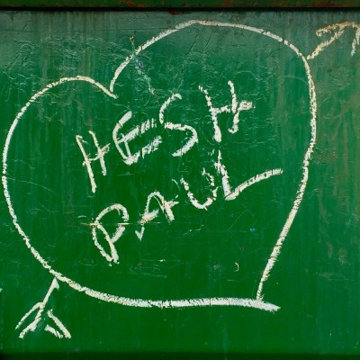 graffiti written on green dumpster with the names "Hesh" and "Paul" in a white heart