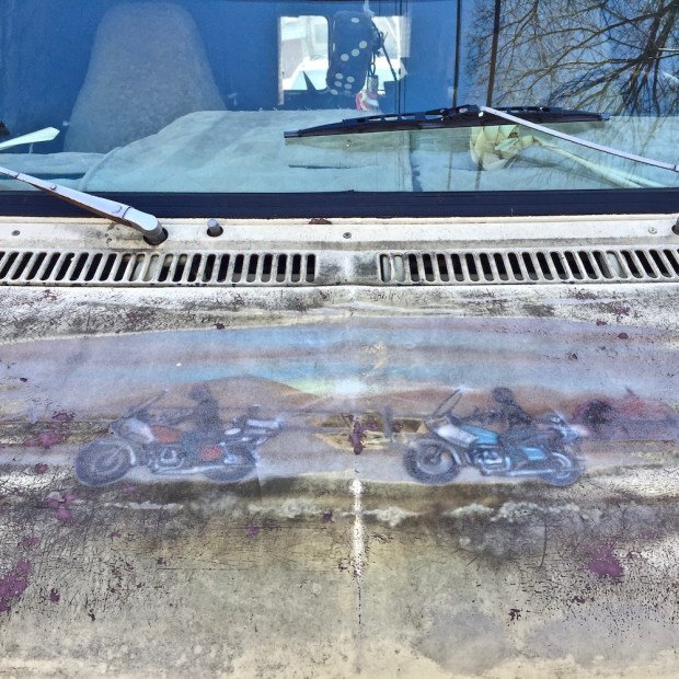 airbrushed artwork of two motorcycles on hood of a van