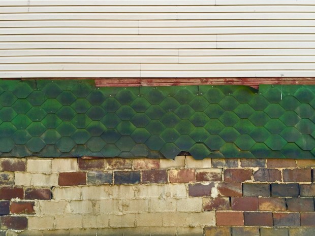 garage wall showing multiple siding materials