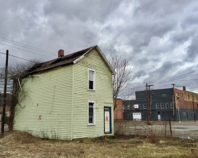 small wood frame house marked with red "X" for demolition, New Kensington, PA