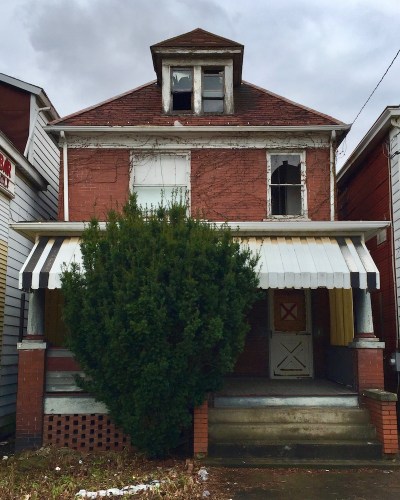 brick house marked with red "X" for demolition, New Kensington, PA