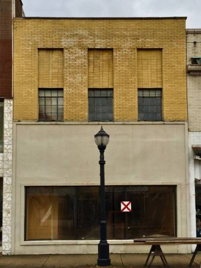 older brick commercial building with red "X" for demolition, New Kensington, PA