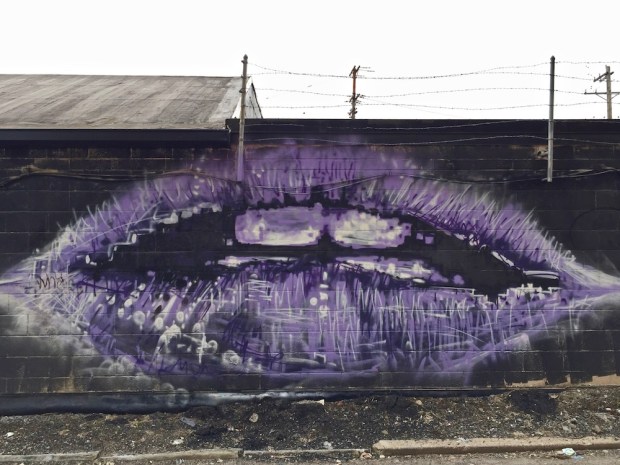 mural of large mouth in purple by artist Jeremy Raymer