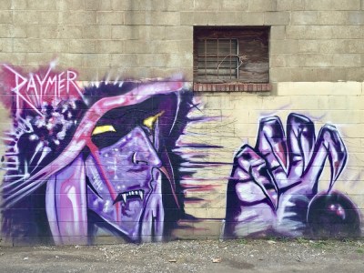 mural of purple witch painted by artist Jeremy Raymer