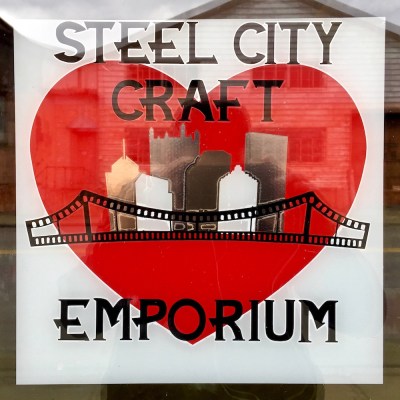 window sign for Steel City Craft Emporium featuring downtown Pittsburgh skyline