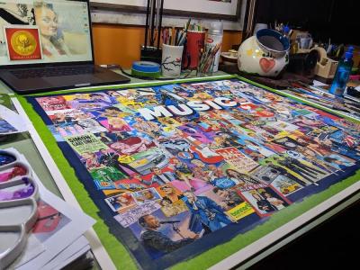 artist's drawing table including finished artwork for a jigsaw puzzle