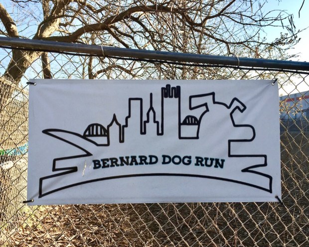 sign for Bernard Dog Run with outline of downtown Pittsburgh skyline