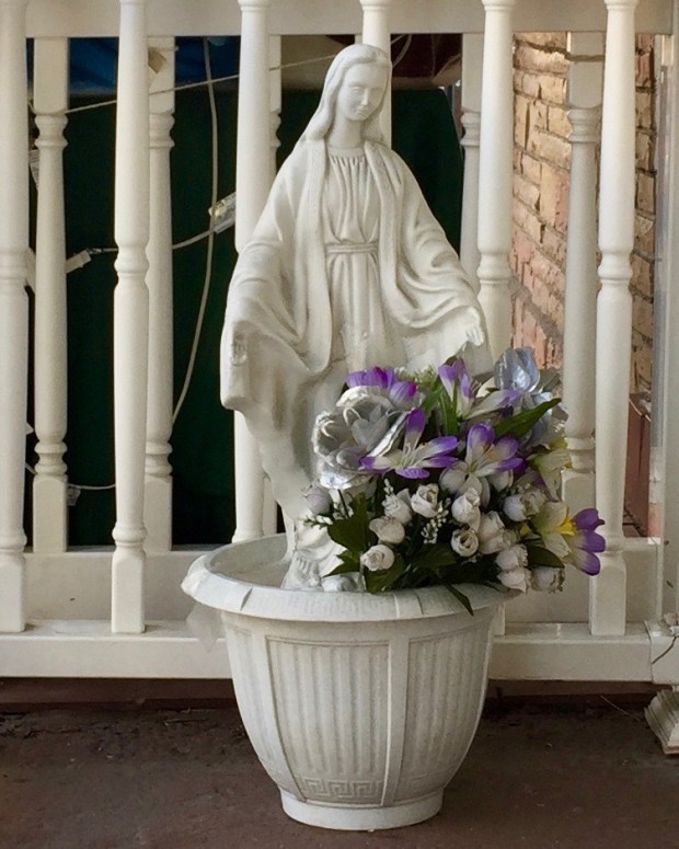 all-white statue of Mary on front porch