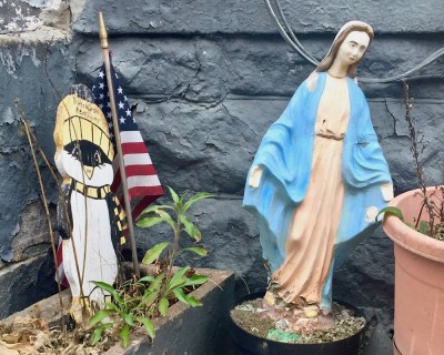 statue of Mary embedded in concrete in flower pot