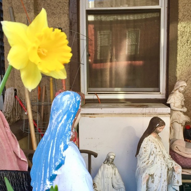 front porch with multiple statues