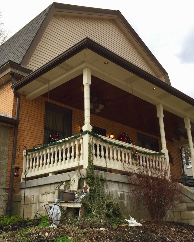 house with statue of Mary among lawn decorations