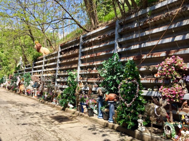 long retaining wall decorated with hundreds of organized objects