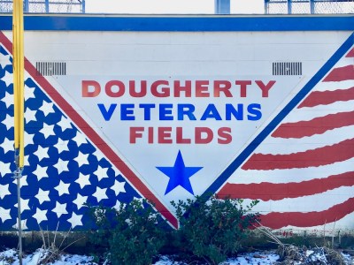 mural painted on cinderblock wall including American flag stars and stripes