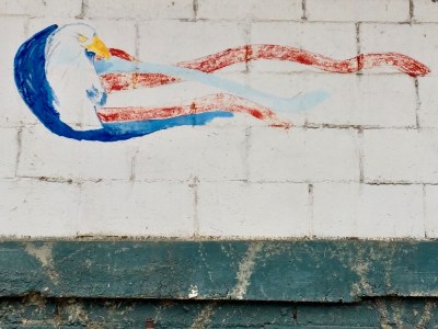 faded mural of bald eagle with American flag