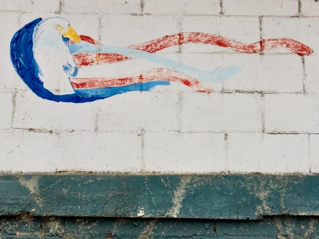 faded mural of bald eagle with American flag