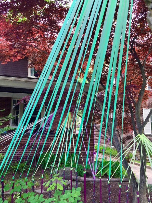house front yard decorated with colored streamers