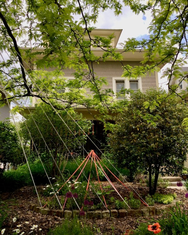 house front yard decorated with colored streamers