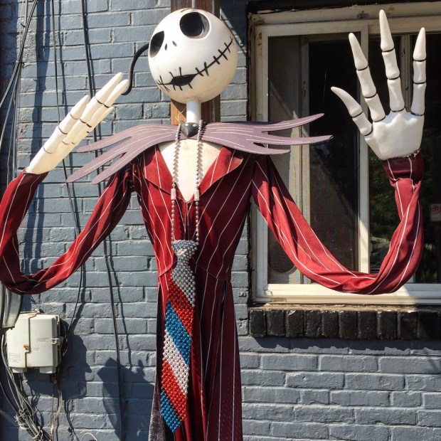 Halloween skeleton decoration wearing long dress and red, white, and blue tie