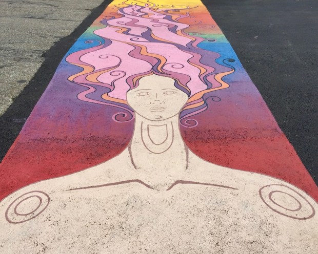 crosswalk mural of woman with wild multicolor hair