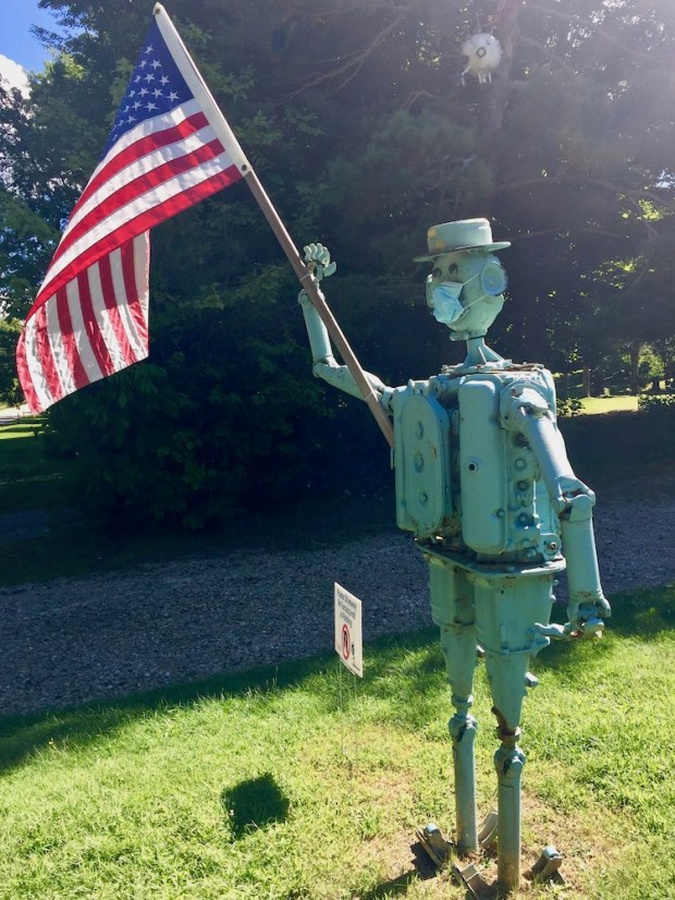 sculpture of man created with auto parts