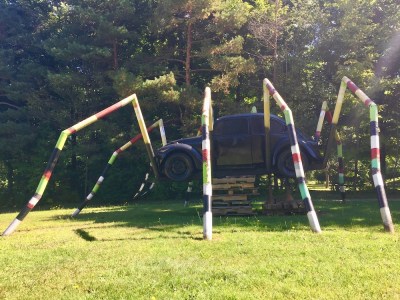 sculpture of giant multicolor spider with Volkswagen Beetle as the body