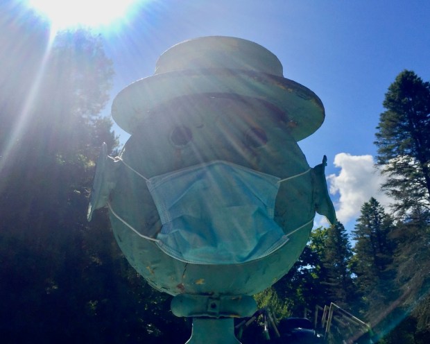 sculpture of man's head made from car parts