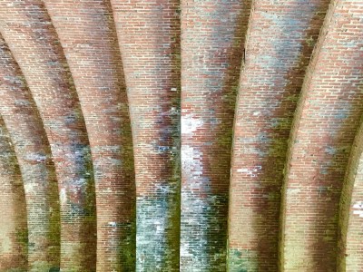 detail of intricate brickwork in arched stone and brick train trestle