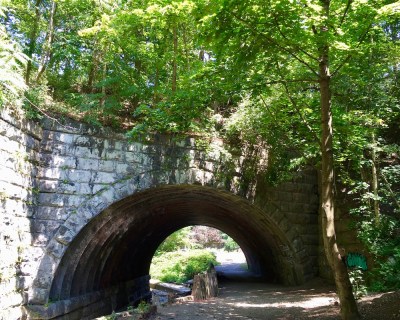 stone arch over creek and footpath
