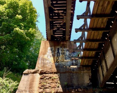 cement and steel train trestle in the woods