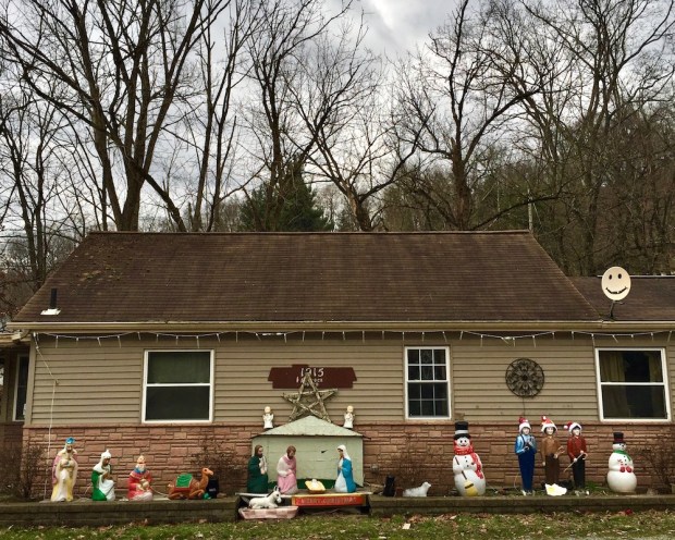 Christmas nativity scene with plastic Mary, Joseph, and baby Jesus decorations outside home