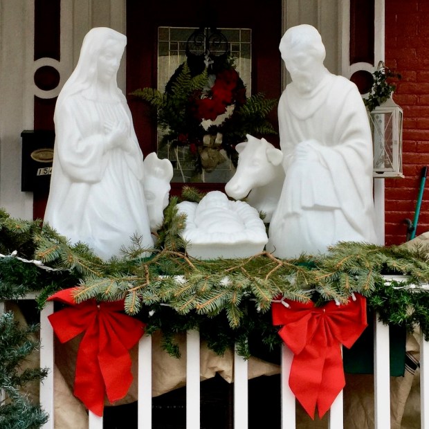 Christmas nativity scene with plastic Mary, Joseph, and baby Jesus decorations outside home