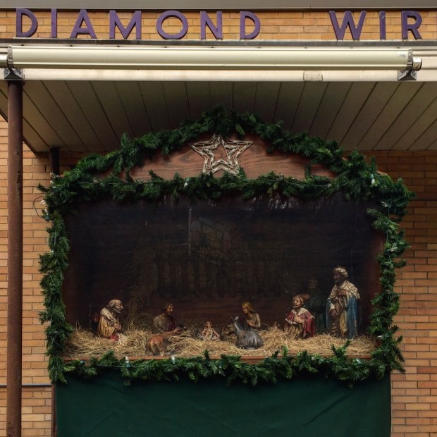 Christmas nativity scene in front of small factory