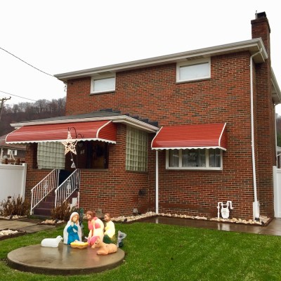 Christmas nativity scene with plastic Mary, Joseph, and baby Jesus decorations outside home