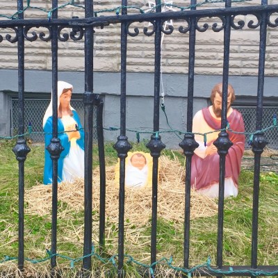 Christmas nativity scene with plastic Mary, Joseph, and baby Jesus decorations outside home