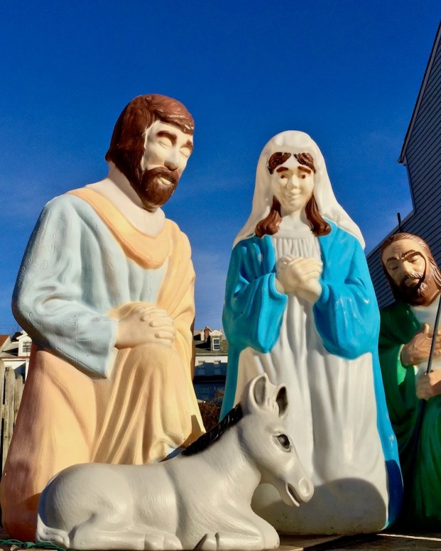 Christmas nativity scene with plastic Mary, Joseph, and baby Jesus decorations outside home