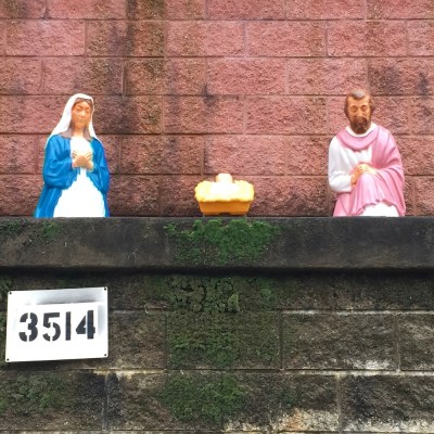 Christmas nativity scene with plastic Mary, Joseph, and baby Jesus decorations outside home