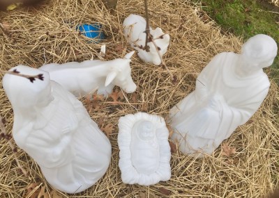 Christmas nativity scene with plastic Mary, Joseph, and baby Jesus decorations outside home