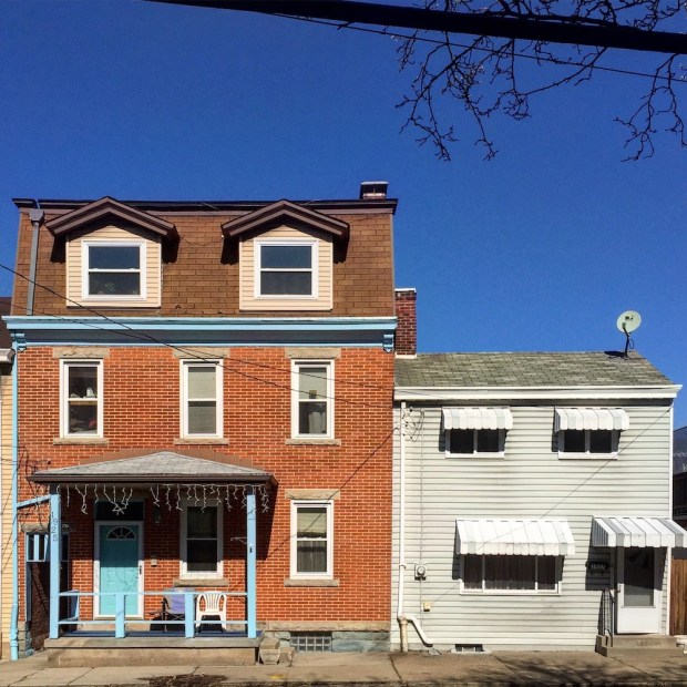 large brick row house next to small row house with aluminum siding, Pittsburgh, PA